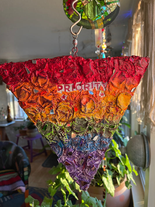 Crunchy repurposed cardboard and bottle cap rainbow pride triangle