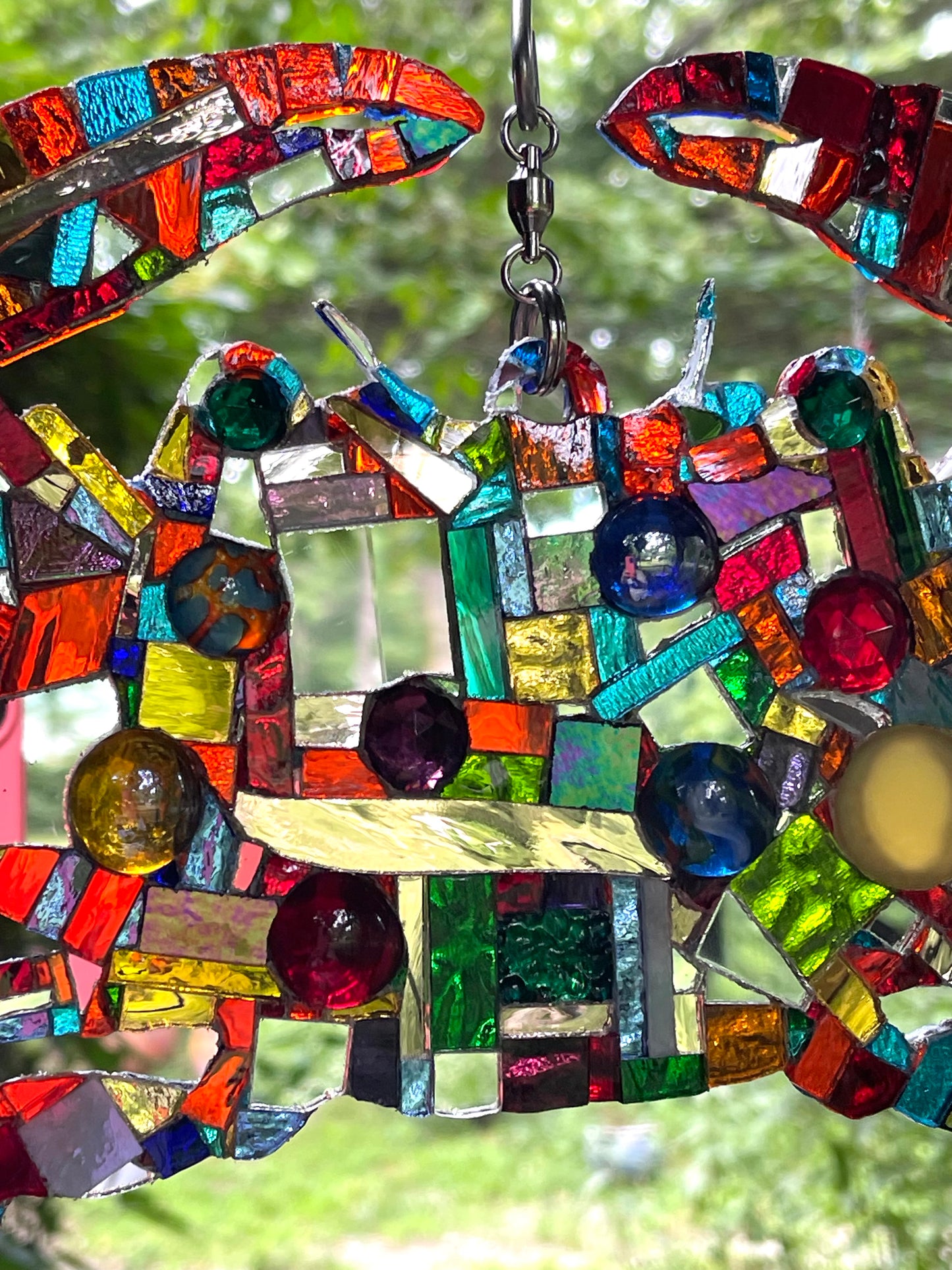 Mirror mosaic-clad steel crab hangs inside or outside on a ball-bearing swivel