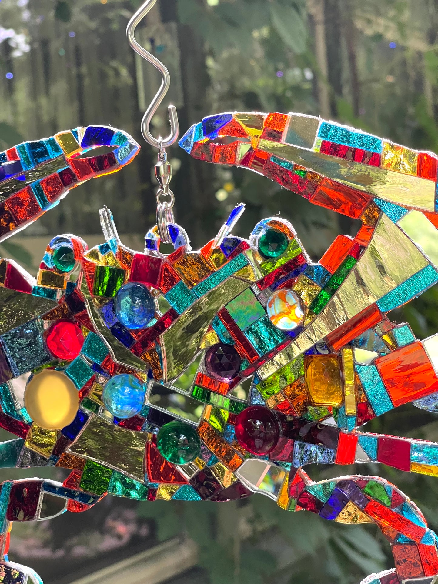 Mirror mosaic-clad steel crab hangs inside or outside on a ball-bearing swivel